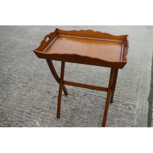 511 - A polished as walnut tray, on folding stand, 26