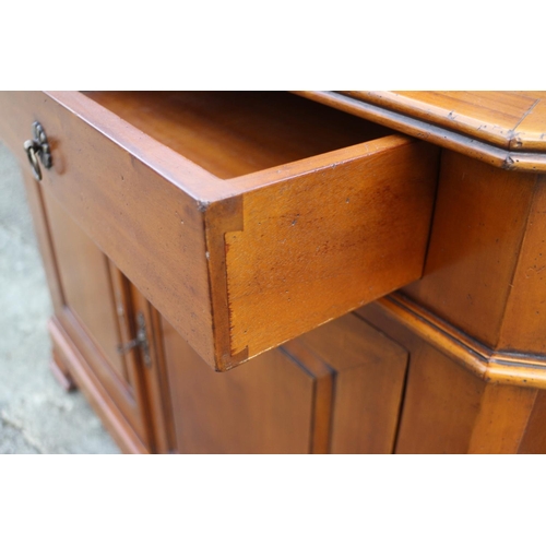 520 - A cherrywood bookcase, the upper section enclosed two glazed panelled doors over two drawers and cup... 