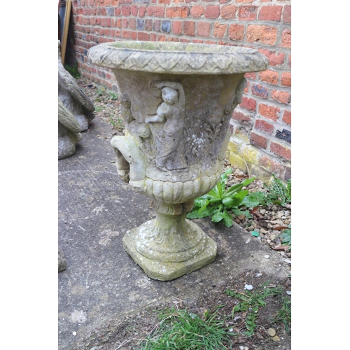 605 - A cast stone campana urn with figure decoration, 16