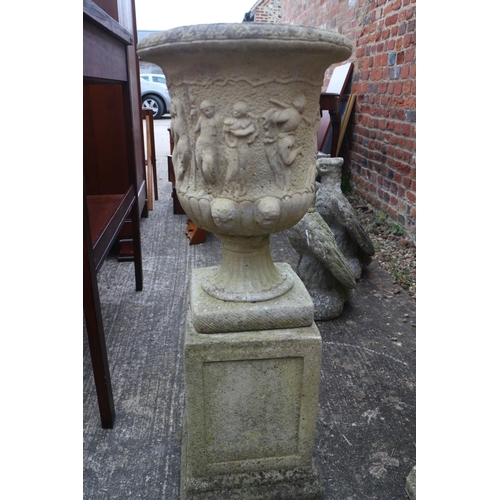 605 - A cast stone campana urn with figure decoration, 16