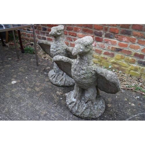 606 - A pair of cast stone eagles, 20