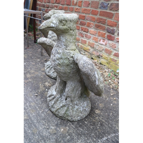 606 - A pair of cast stone eagles, 20