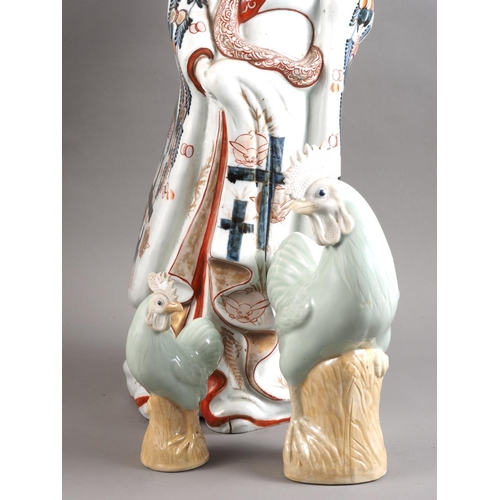 84 - An Imari porcelain figure of a woman with replacement head, 20 1/2