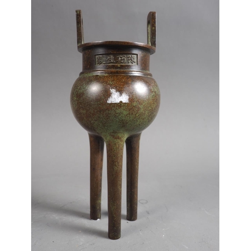 90 - A Chinese bronze censor, formed as a cauldron, on three cylindrical supports, 7