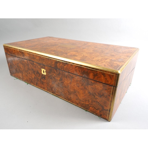 137 - A 19th century burr walnut and brass mounted writing box with fitted interior and three 