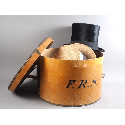 162 - An early 20th century wooden hat box, an early 20th century silk top hat, a boater, etc