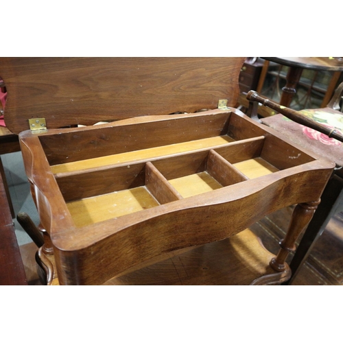 530 - An early 20th century walnut work table with lift-up lid and undertier, on turned supports, 25