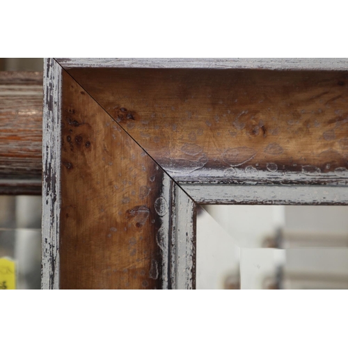 471 - A bevelled edge wall mirror, in walnut frame, plate 23 1/2