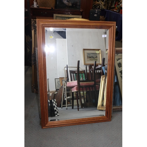 480 - A waxed pine framed wall mirror with bevelled plate, 39