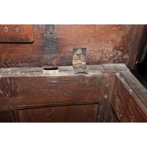 417 - An early 18th century carved oak triple panel front coffer with scroll design and planked top, on st... 