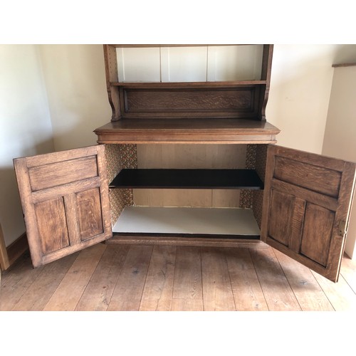 490 - An early 20th century oak bookcase with open shelves over cupboards, on block base, 50