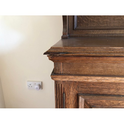 490 - An early 20th century oak bookcase with open shelves over cupboards, on block base, 50