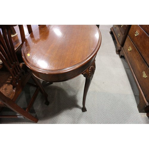 463 - A mahogany oval side table, on shell decorated cabriole supports with ball and claw feet, 36