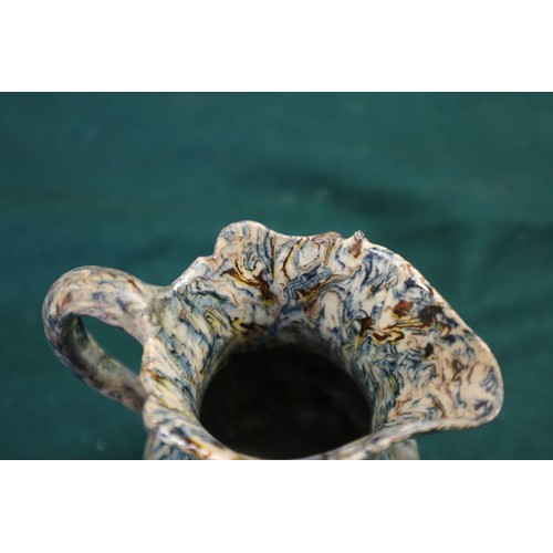 12 - A mid 18th century agate ware cream jug, on lion mask and paw feet, 4