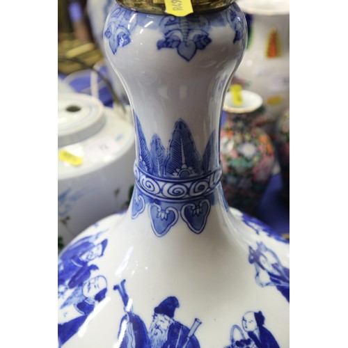 205 - A pair of Chinese blue and white bulbous figure decorated vases, now table lamps, on hardwood bases,... 