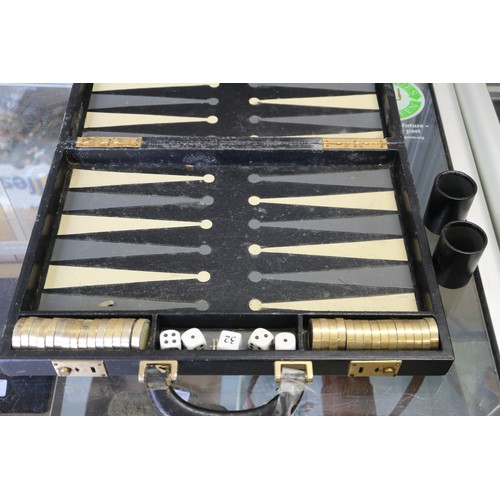 152 - Two backgammon sets, in leather travel cases and a clown