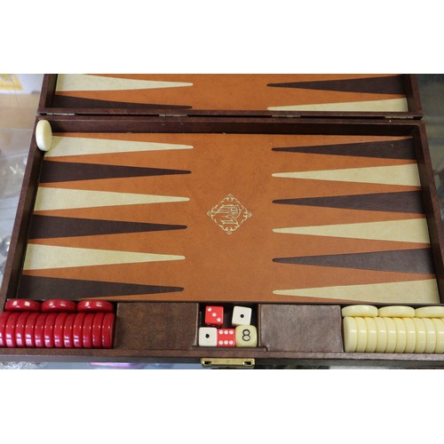 152 - Two backgammon sets, in leather travel cases and a clown