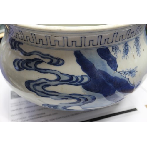 73 - A Chinese blue and white jardiniere with figures in a landscape, 9 1/2