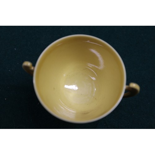 71 - A Chinese yellow glazed two-handled cup with incised beast decoration and six-character mark to base... 