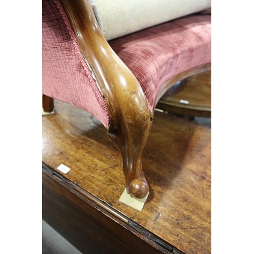 438 - A late Victorian carved walnut showframe chaise longue, upholstered in a claret velour, on cabriole ... 