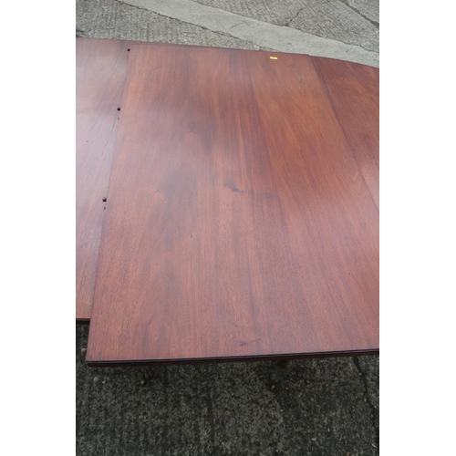 535 - A mahogany double pedestal dining table of Georgian design with one extra leaf, on twin turned colum... 