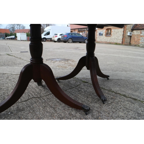 544 - A mahogany and banded double pedestal dining table with one extra leaf, on vase turned columns and t... 