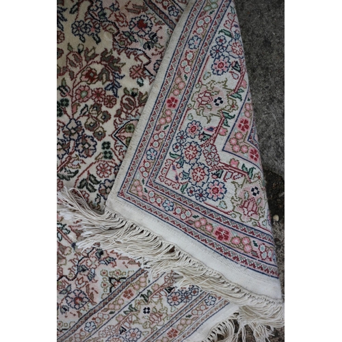 601 - A Turkish silk rug with all-over floral design on a cream and pink ground and multi-borders in shade... 