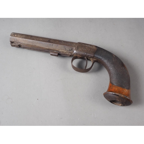 132 - A 19th century percussion cap pistol with octagonal barrel and engraved walnut handle, 9