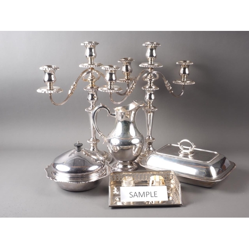 222 - A pair of silver plated three-light table candelabra, a pair of single light candlesticks, a plated ... 