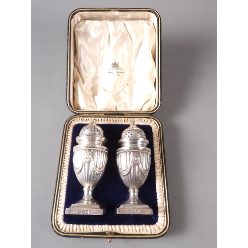 236 - A pair of Adam style silver pedestal pepper shakers, in fitted case, 4.6oz troy approx