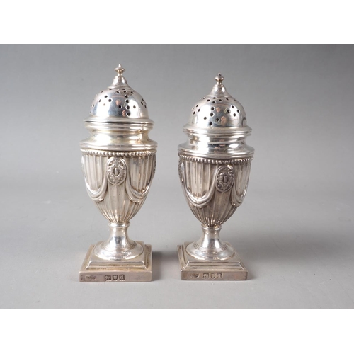 236 - A pair of Adam style silver pedestal pepper shakers, in fitted case, 4.6oz troy approx