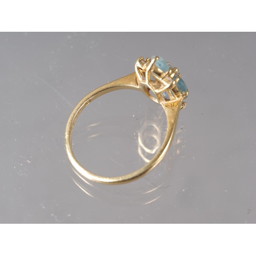 255 - An 18ct gold diamond and aquamarine dress ring, size P, 3.4g