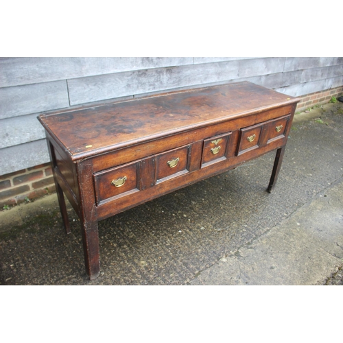 410 - An 18th century fruitwood dresser base, fitted one short and two long fielded panel front drawers, o... 