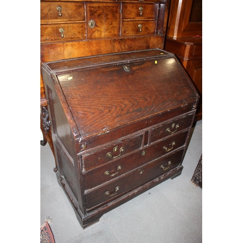 411 - An early 18th century fall front bureau with fitted interior cupboard and well over two short and tw... 