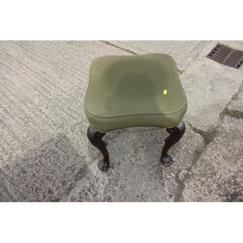 454 - A 19th century carved mahogany shape top stool, on acanthus scroll supports and lion paw feet, 20