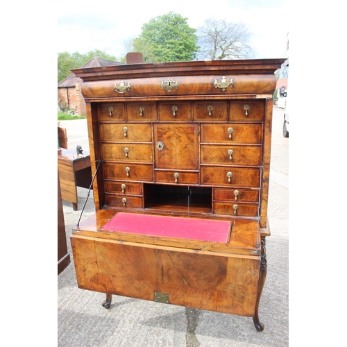 457 - An early 18th century figured walnut and feather banded secretaire abbatant, the upper section fitte... 