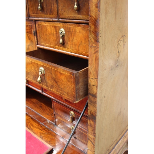 457 - An early 18th century figured walnut and feather banded secretaire abbatant, the upper section fitte... 