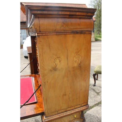 457 - An early 18th century figured walnut and feather banded secretaire abbatant, the upper section fitte... 