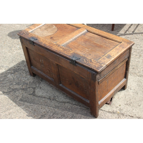 458 - An 18th century carved oak two panel front coffer, on stile supports, 35