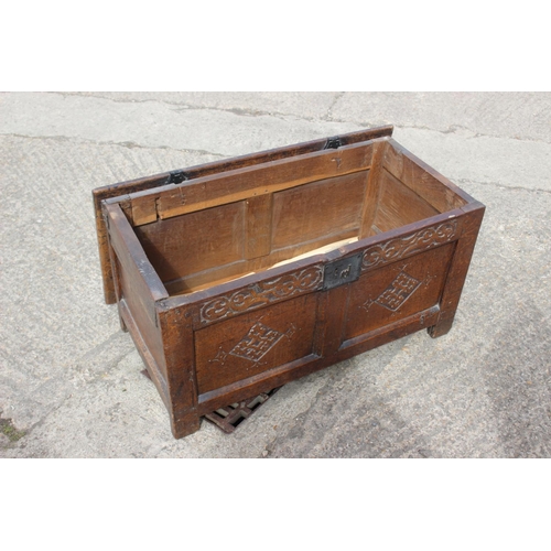 458 - An 18th century carved oak two panel front coffer, on stile supports, 35