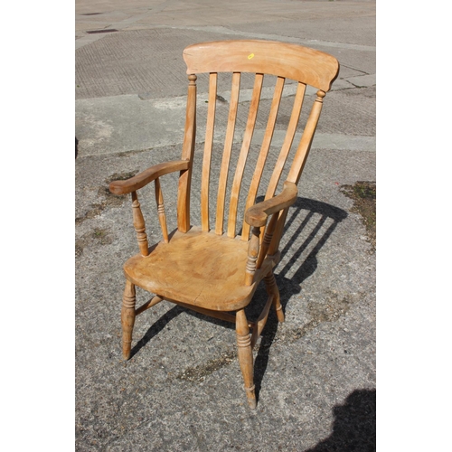 522 - A Windsor farmhouse lath back elbow chair, on turned and stretchered supports and a splat back elbow... 