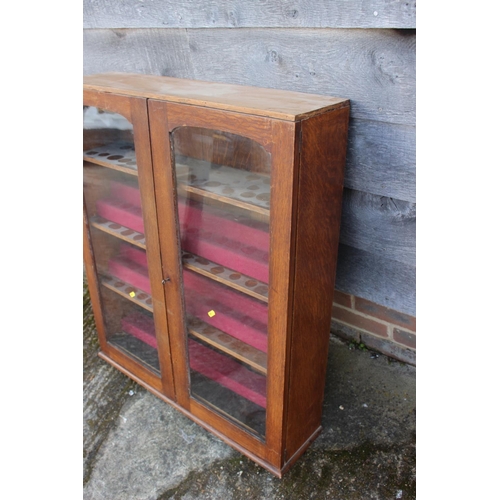 525 - An oak display cabinet enclosed two shape top glazed panel doors, 31