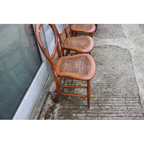 542 - A set of four polished as walnut cane seat bedroom chairs, on turned splay supports