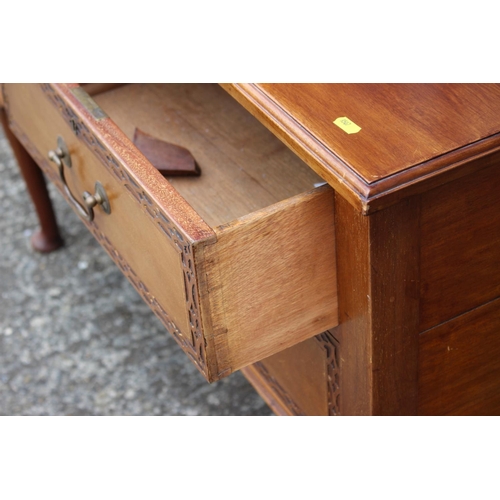 568 - A 1920s carved walnut chest of two short and one long drawer, on cabriole supports and pad feet, 45