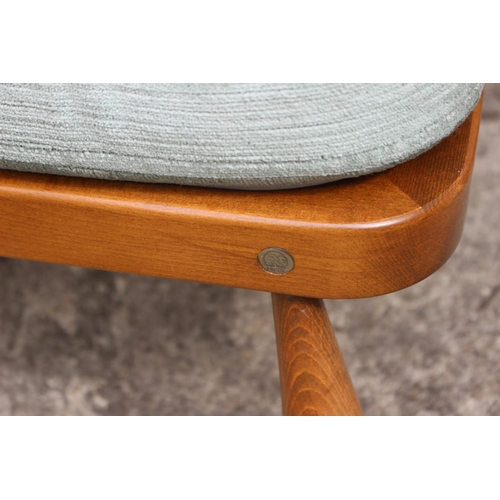 570 - An Ercol stool with cushion seat, on turned supports, 20