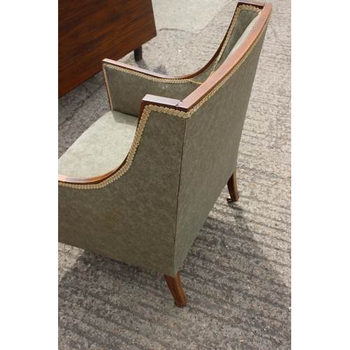 574 - An Edwardian walnut line inlaid armchair, upholstered in a clouded green, on square taper supports