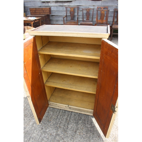 584 - A cream painted pine cupboard enclosed two doors with four shelves, 28 1/2