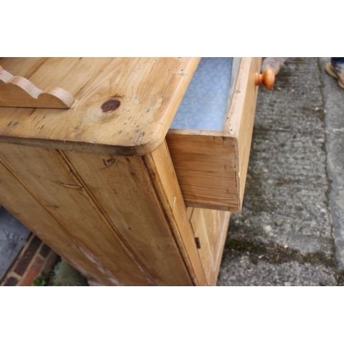 588 - A waxed pine dresser, the upper section with arcade and four spice drawers over two drawers and cupb... 