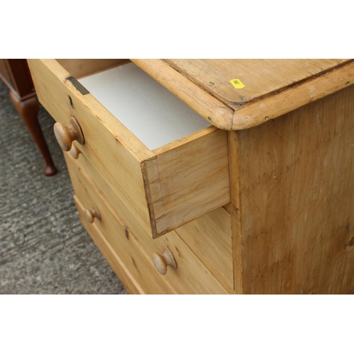 594 - A waxed pine chest of two short and three long drawers with knob handles, on block base, 41