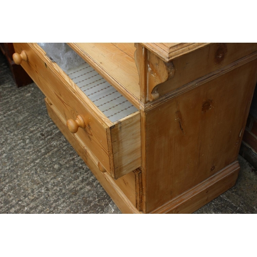 595 - A waxed pine dressing chest, fitted mirror over shaped top, two drawers and two long drawers, on blo... 